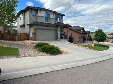Charming two-story home with a two-car garage, rock landscaping and a concrete driveway at 3173 Youngheart Way, Castle Rock, CO 80109