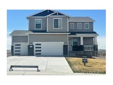 Charming two-story home with a three car garage and landscaped front yard at 42992 Colonial Trl, Elizabeth, CO 80107