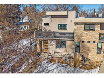 Modern two-story home with stone accents and a private patio at 3323 W Hayward Pl, Denver, CO 80211