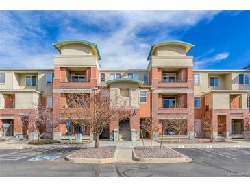 Beautiful condominium building with brick and tan siding and parking spaces, inviting curb appeal at 4100 Albion St # 612, Denver, CO 80216
