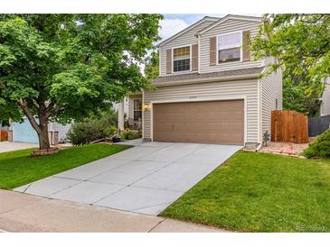 Charming two-story home with a well-maintained lawn and attached two-car garage at 2905 S Deframe Way, Lakewood, CO 80228
