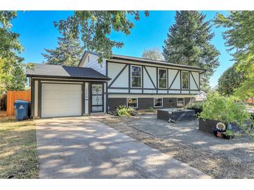 Charming home featuring a unique Tudor style, complemented by a well-maintained yard and attached garage at 16193 E Dickenson Pl, Aurora, CO 80013