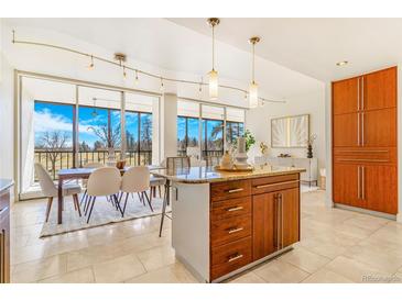 Bright open kitchen and dining room area with natural light and neutral color palette at 1201 N Williams St # 3B, Denver, CO 80218