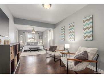 Comfortable bedroom with ceiling fan, sitting area and neutral tones provides relaxation at 3541 E 118Th Ave, Thornton, CO 80233