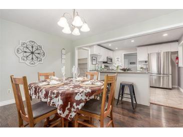 Dining room that is open to kitchen, featuring wood table with seating for four at 3541 E 118Th Ave, Thornton, CO 80233