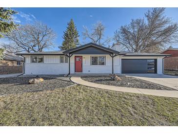 Charming updated home featuring a bright red door, fresh white paint, and an attached garage at 8340 W 70Th Ave, Arvada, CO 80004