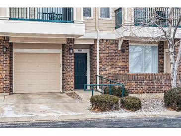 Inviting townhome facade with brick accents, a single car garage, and a welcoming front door at 1861 Mallard Dr, Superior, CO 80027