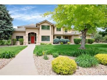 Inviting two-story home features a red door, lush landscaping, and well-manicured lawn at 9669 E Prentice Cir, Greenwood Village, CO 80111