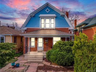 Charming two-story home with a blue and red brick exterior, a covered porch, and well-maintained landscaping at 3361 W 29Th Ave, Denver, CO 80211