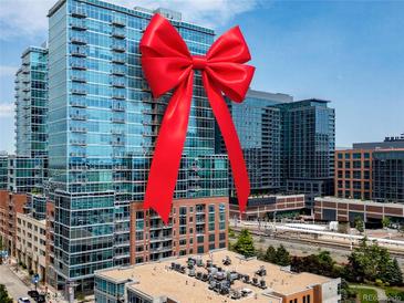 Modern high rise with a red bow on the building at 1700 Bassett St # 1119, Denver, CO 80202
