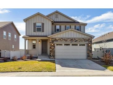 Charming two-story home featuring stone accents, a two-car garage, and well-maintained landscaping at 6214 Long Branch Dr, Parker, CO 80134