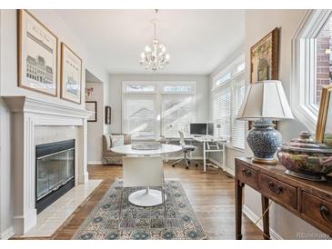 Bright dining area features a fireplace, hardwood floors, and ample natural light at 45 Jackson St # A, Denver, CO 80206