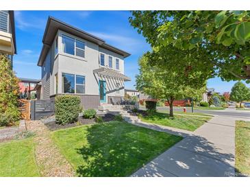Beautiful two-story home with a modern design, a manicured lawn, and nice curb appeal at 1813 W 67Th Ave, Denver, CO 80221
