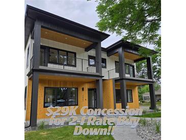Modern two-story home boasts striking architectural details, including dual balconies and sleek black accents at 2405 S Franklin, Denver, CO 80210