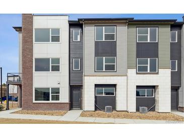 Modern townhome showcasing varied textures and contemporary design elements at 451 Interlocken Blvd # 104, Broomfield, CO 80021