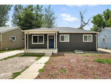 Charming single-story home features a well-maintained lawn and a welcoming front porch, creating an inviting curb appeal at 1941 Alton St, Aurora, CO 80010