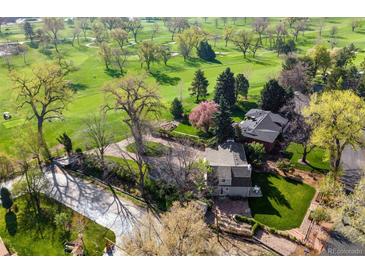 Stunning aerial view of home overlooking the golf course and tree-lined street at 6990 W 9Th Pl, Lakewood, CO 80214