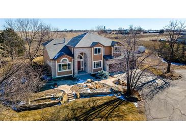 Two-story house with stone accents and landscaping; driveway and yard visible at 15050 Harrison St, Brighton, CO 80602