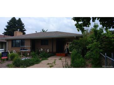 Charming home with brick exterior, mature trees, and covered front porch and driveway at 2008 Moline St, Aurora, CO 80010