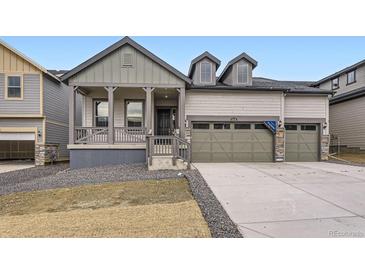 Charming home with covered porch, three-car garage, and modern architectural details at 15616 W Beloit Ave, Morrison, CO 80465