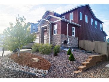 Charming two-story home features stone accents, landscaped front yard, and inviting curb appeal at 4840 Point Mesa St, Castle Rock, CO 80108