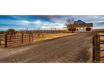 Gated entrance leads to a charming home with a long driveway at 52900 E 88Th Ave, Strasburg, CO 80136