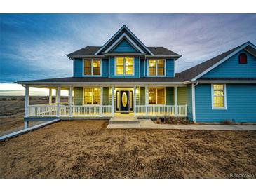 Charming two-story home with a covered porch and well-manicured landscaping at 52900 E 88Th Ave, Strasburg, CO 80136