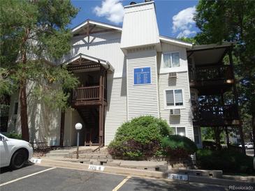 Two story condo building with wood balconies and stairs, trimmed with light siding at 17331 E Mansfield Ave # 311L, Aurora, CO 80013