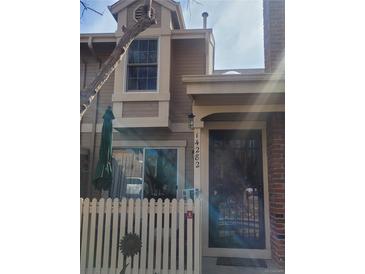 Charming two-story home with a welcoming entrance and manicured front yard at 14282 E Radcliff Cir, Aurora, CO 80015