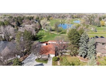 Breathtaking aerial view of the home overlooking a lush golf course and serene water features at 4749 Old Post Ct, Boulder, CO 80301
