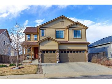 Charming two-story home boasts a three-car garage and a beautifully maintained front yard at 2065 E 150Th Pl, Thornton, CO 80602