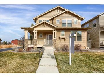 Two-story Craftsman home with stone accents and a welcoming porch at 21719 E Tallkid Ave, Parker, CO 80138