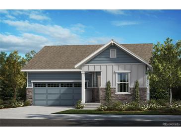 Charming single-story home featuring stone accents, a gray garage door, and beautifully landscaped front yard at 5726 N Jebel Way, Aurora, CO 80019
