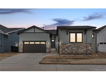 Charming two-story home featuring stone accents, a two-car garage and inviting curb appeal at 11452 Autumn Moon St, Littleton, CO 80125