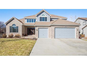 Charming two-story home with attached two car garage and manicured front lawn at 23453 Painted Hills St, Parker, CO 80138