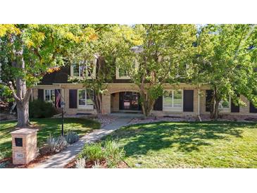 Charming two-story brick home with well-maintained lawn and mature trees providing shade and curb appeal at 5432 S Dayton Ct, Greenwood Village, CO 80111