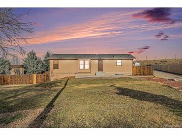 Charming single-story home features a well-maintained lawn and inviting front entrance at 7892 Beverly Blvd, Castle Pines, CO 80108