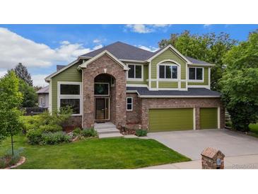 Charming two-story home with brick accents, manicured lawn, and a three-car garage at 2240 Summitview Dr, Longmont, CO 80504