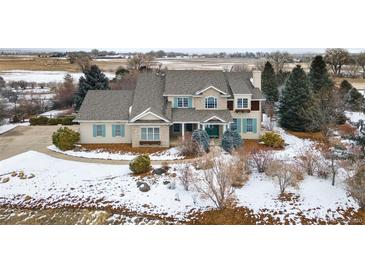 Charming two-story home boasting a stone and stucco facade with a professionally landscaped front yard at 8916 Prairie Knoll Dr, Longmont, CO 80503