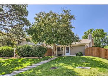Charming home with a well-manicured lawn and mature tree providing ample shade at 2896 W 119Th Ave, Westminster, CO 80234