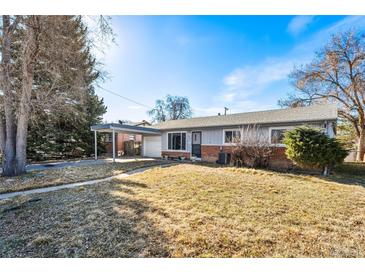 Charming single-story home with a covered carport and a well-maintained front yard under a bright sky at 6880 W Airview Ave, Lakewood, CO 80232