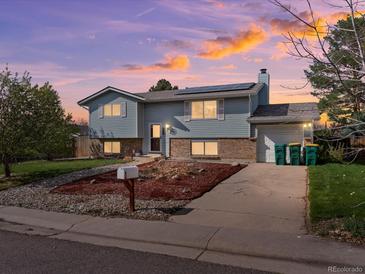 Charming two-story home with solar panels, attached garage, and low-maintenance front yard at 416 Pluto Ct, Lone Tree, CO 80124