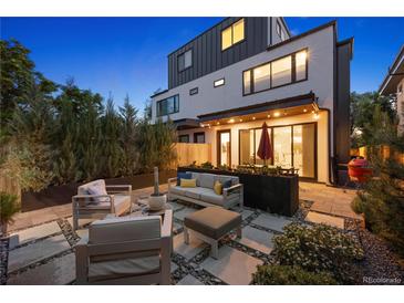 Inviting backyard patio with modern outdoor seating and landscaped planters under ambient lighting at 2248 S Lincoln St, Denver, CO 80210