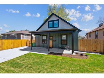 Charming home with a covered porch, well-maintained lawn, and a newly paved driveway at 3680 S Logan St, Englewood, CO 80113
