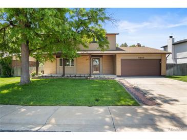 Charming two-story home with a well-maintained lawn and attached two car garage at 6240 W 110Th Pl, Westminster, CO 80020