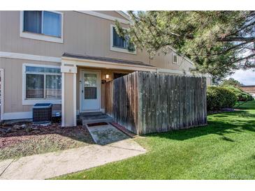 Charming townhome entrance featuring a quaint fenced front yard and well-maintained landscaping at 8798 Chase Dr # 2, Arvada, CO 80003