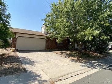 Ranch style home with attached two-car garage and mature landscaping at 17900 E Asbury Dr, Aurora, CO 80013