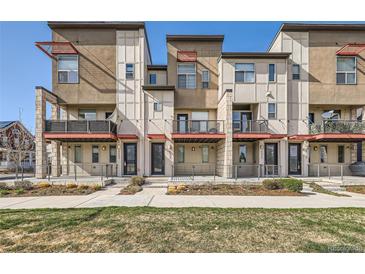 Modern townhome exterior featuring private balconies, stylish architecture, and well-maintained landscaping at 9023 E Northfield Blvd, Denver, CO 80238