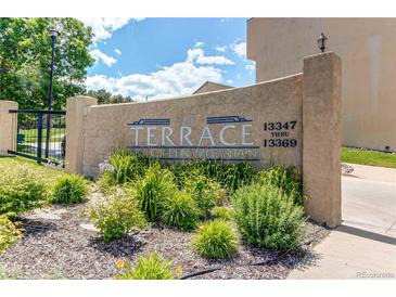 Attractive sign for The Terrace At Green Mountain community with lush landscaping at 13351 W Alameda Pkwy # 203, Lakewood, CO 80228