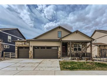 Charming home featuring a three-car garage and inviting covered front porch at 4815 Cattle Cross Rd, Castle Rock, CO 80104